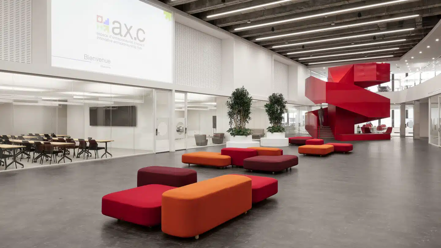 The Ax.c atrium in downtown Montréal: modular seating, indoor trees, and a red spiral staircase